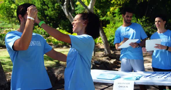 Volunteers giving high five to each other 4k alt