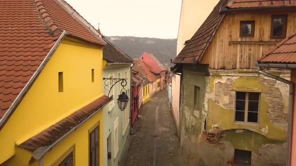 Beautiful view of a stone lane of the famous Sighisoara medieval town in cloudy day. Transylvania Ro alt