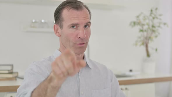 Middle Aged Man Pointing Finger and Inviting  alt