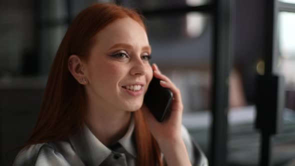 Closeup Face of Cheerful Young Woman Holding Mobile Phone Happily Calling and Chatting at Home alt