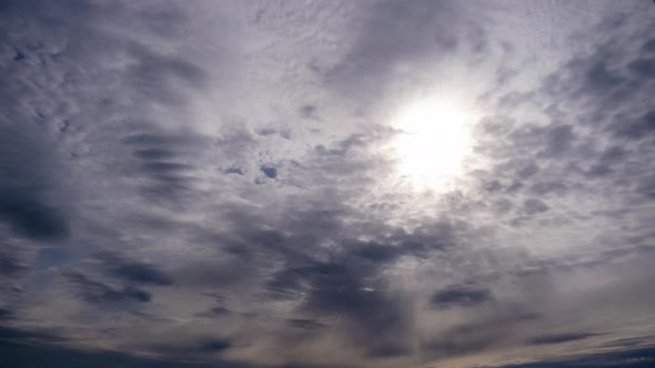 Layered Clouds Move in Blue Sky Under Bright Sun Fluffy Cloudscape Timelapse alt