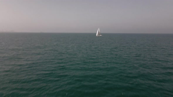 Yacht with Reflection Sailing on Open Sea Aerial