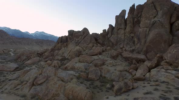 Aerial shot of a young man backpacker camping with his dog in a mountainous desert alt