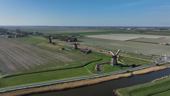 Historic Dutch Windmills in a Farm and Grass Field Landscape in The Netherlands Holland alt