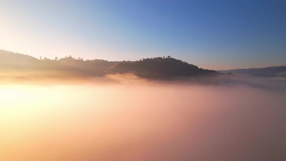 4K Aerial video Beautiful sunrise above dense clouds and fog in the morning alt