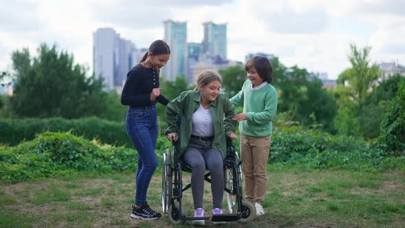 Front View Motivated Teenage Girl Standing Up From Wheelchair Making Steps with Friends Helping alt