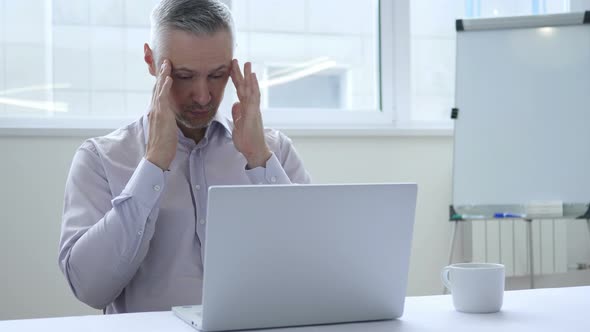 Headache, Stressed Businessman Working on Laptop alt