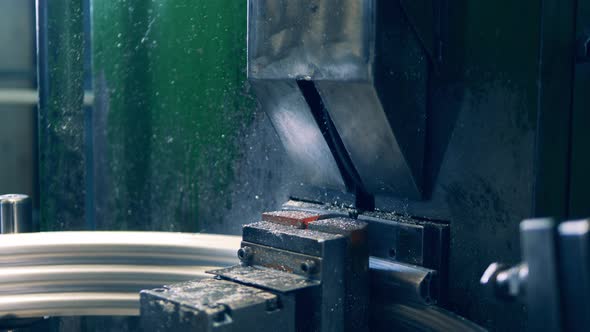 Factory Machine Is Cutting a Metal Wheel Rim alt