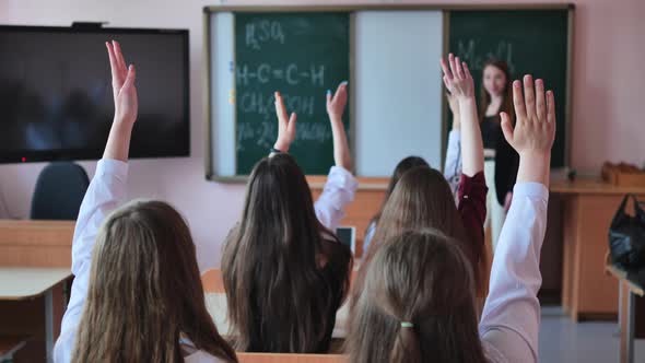 High School Students Stretch Their Hands in the Lesson alt