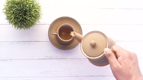 Pouring Tea From a Tea Ceremony Top Down alt