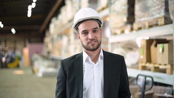 Portrait of a young man, a production manager. Young bearded boss smiling alt