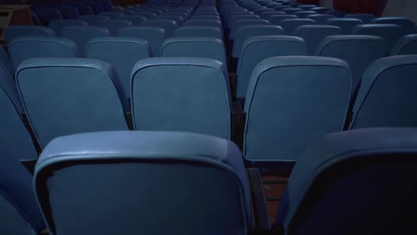 Empty cinema. Film premiere without spectators. Movie spotlight. Blue chairs alt
