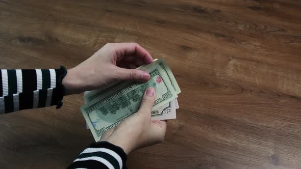 Female Hands Hold Dollar Bills As Fan Shape and Inspecting to Found Damaged Banknotes
