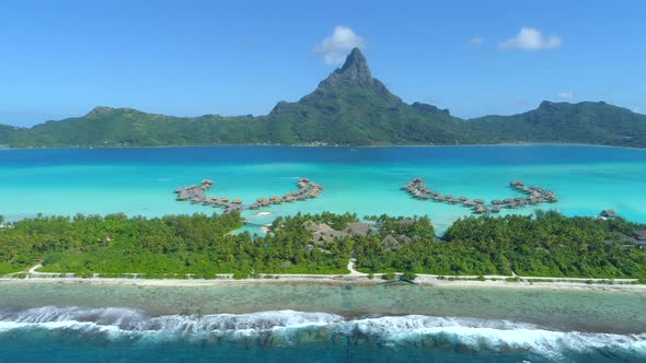 Aerial drone view of a luxury resort and overwater bungalows in Bora Bora tropical island alt