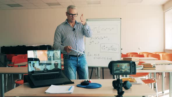 Male Teacher is Explaining Formulas for Online Students alt