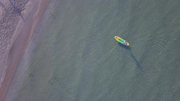 Aerial Drone View of a Man Paddling on a Sup Stand Board