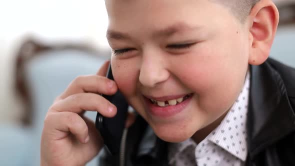 Little Schoolboy Talking on a Smartphone alt