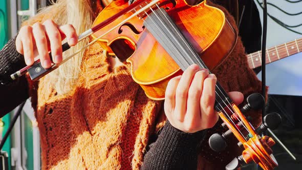 Close Up Footage of Girl with Long Hair Playing Violin Outside in Sunny Weather Music Group alt
