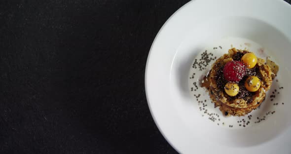 Granola bars with raspberry and golden berry in plate alt