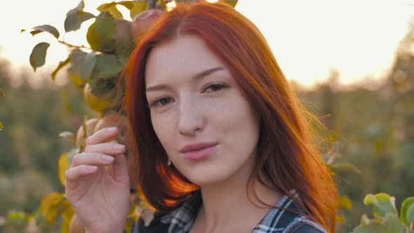 Portrait of Redhead Woman on Nature alt
