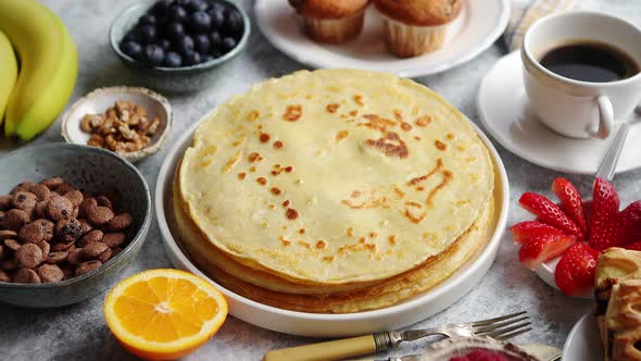 Breakfast Table Setting with Fresh Fruits, Pancakes, Coffee, Croissants alt