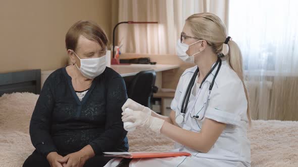 Senior woman and doctor. Medical consultation at home. alt