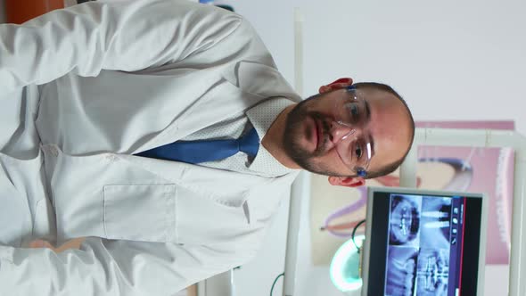 Vertical Video Man Stomatologist Speaking on Video Camera alt