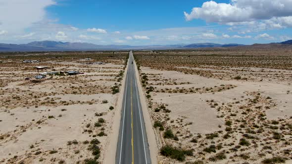 Aerial View of Endless Desert Straight Dusty Asphalt Road in Joshua Tree Park. USA. alt