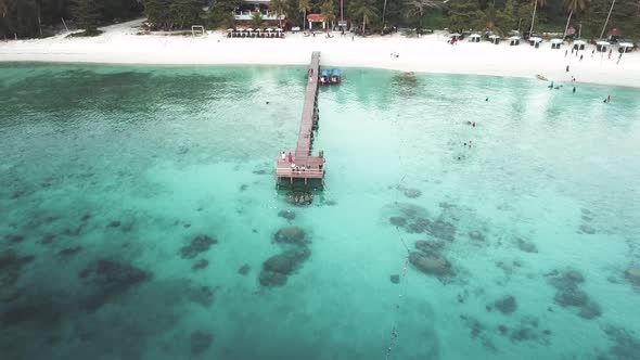 Drone footage from Malaysia island. Beach side tropical season feel. alt