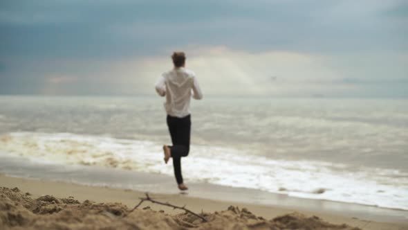 Slim Tall Guy Running Into Sea in Clothes Enjoying Freedom in Slow Motion Connection with Force of alt