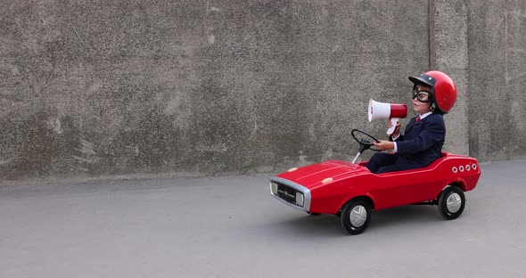 Funny businessman driving retro pedal car outdoor. Slow motion alt