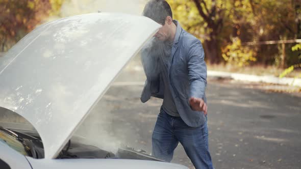 Smoke From Under the Hood of a Car alt
