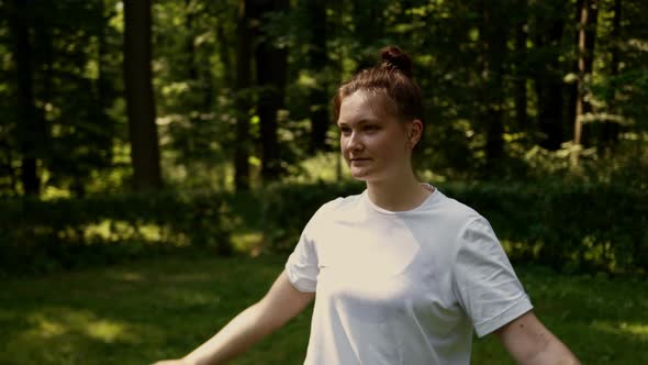 A Woman is Engaged in Pilates Sports in the Early Morning in a Community Park alt