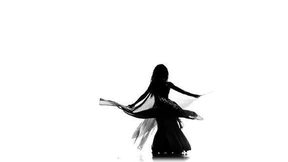 Talanted Exotic Belly Dancer Woman Go on Dance, Uses Wings, on White, Slow Motion, Silhouette alt