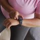 Video of midsection of plus size african american woman in sport clothes checking smartwatch - VideoHive Item for Sale