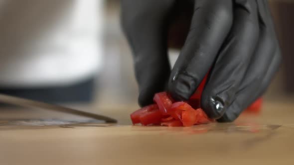 Chef picks up a sliced ​​red pepper with a knife, Apple ProRes slow-mo alt