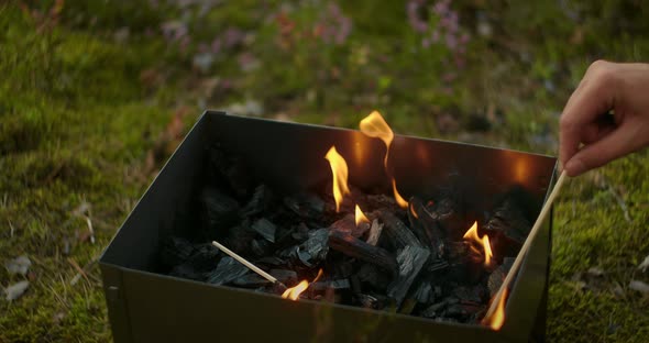 Flame in Chargrill, Person Is Mixing Coals, Detail View, Slow Motion Shot, Camping and Picnic at alt