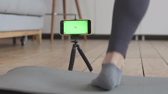 Young Woman's Online Workout. Green Screen and Marks on her Phone.