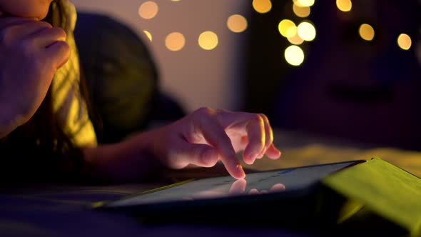 Close up shot of female hand using tablet and touching slide on screen.