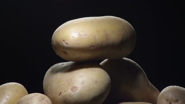 Potatoes Gyrating on Black Background alt