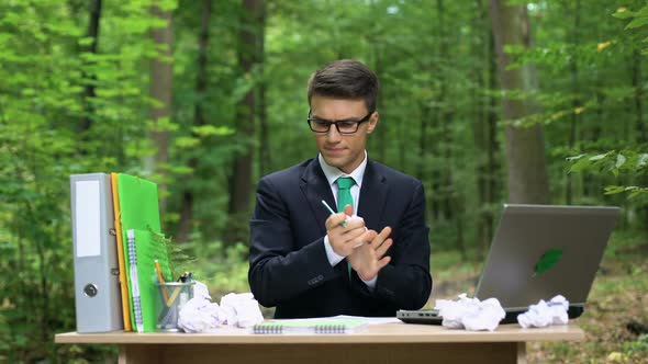 Satisfied Businessman Making List of Creative Ideas, Inspired by Nature in Park alt