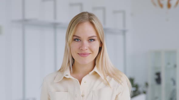 Attractive young woman looking into the camera. Portrait of a young smiling girl alt