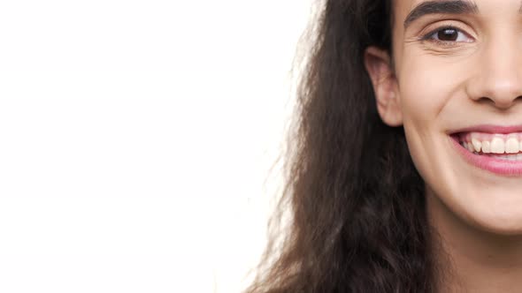 Extreme Closeup Halfside Portrait of Gorgeous Woman Having Dark Curly Hair Laughing on Camera with alt