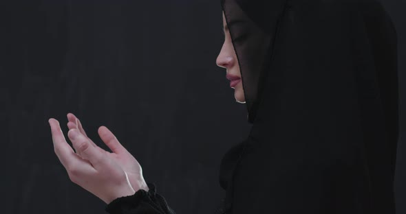 Portrait of Beautiful Muslim Woman in Fashionable Dress with Hijab Making Traditional Prayer to God alt