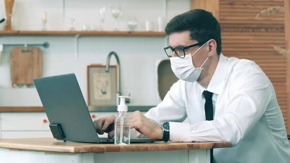 Man Work at Home in Quarantine During Covid-19 Outbreak. A Man on Quarantine Is Working on a Laptop alt