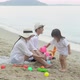 Happy asian family playing on the beach in summer together with fun. - VideoHive Item for Sale