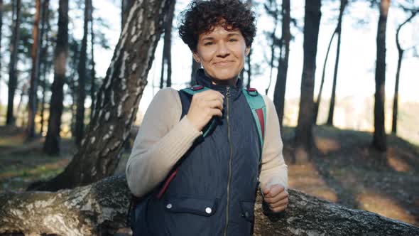 Portrait of Attractive Lady Backpacker Standing in Forest with Happy Smile alt