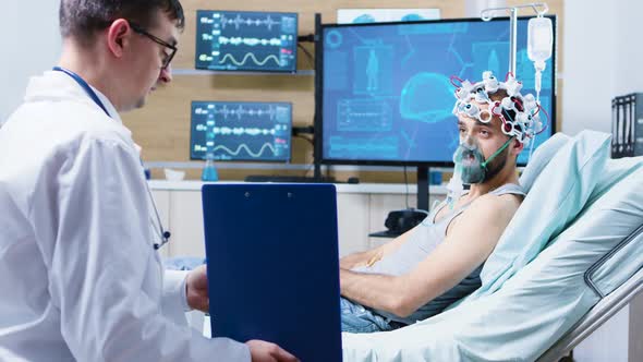 Patient in a Neuroscience Centre Wearing Brainwaves Scanning Headset and Air Mask alt