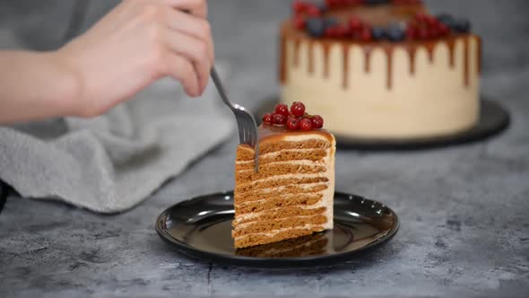 Piece of Layer Caramel Cake with Cream and Fresh Berries