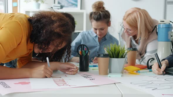 Slow Motion of Cheerful Women Making Posters About Feminism and Talking Enjoying Creative Activity alt